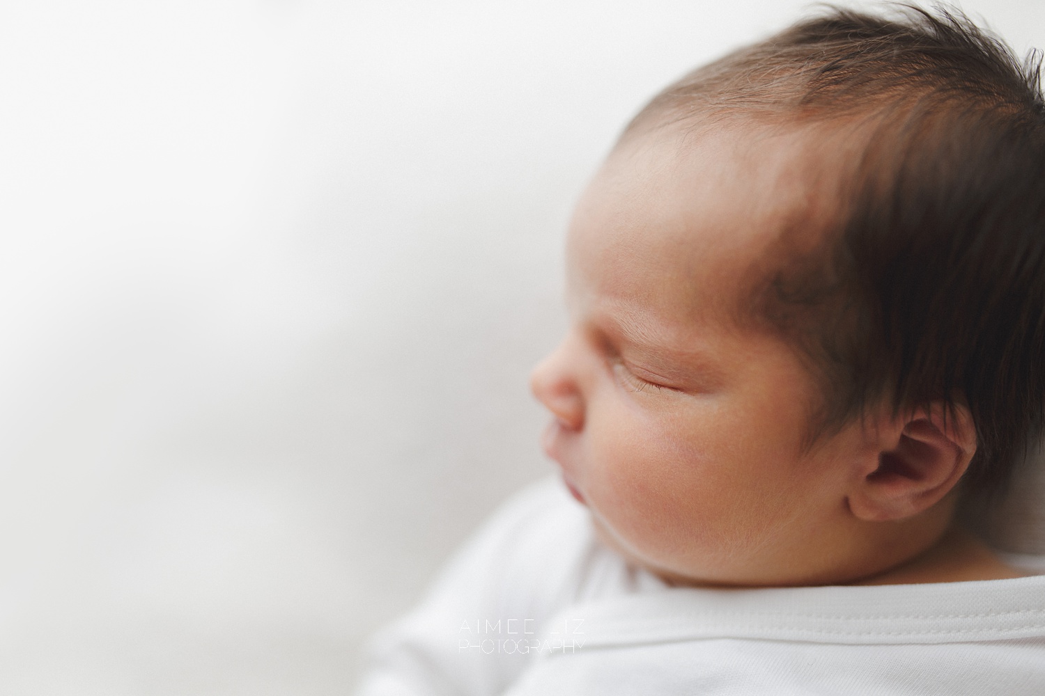 white onesie newborn photographer