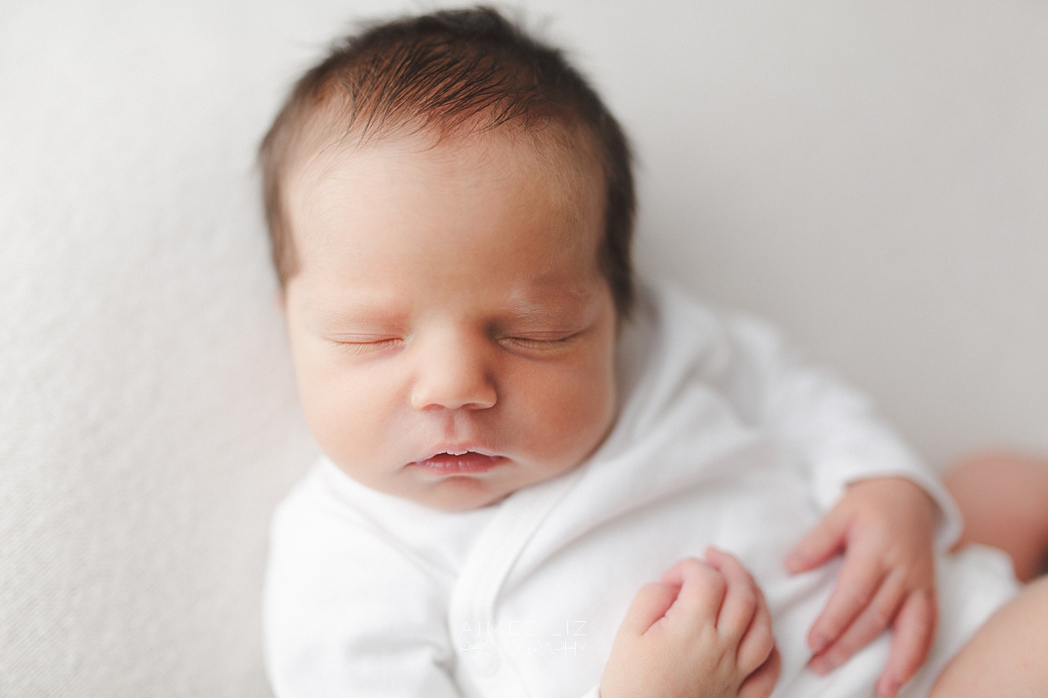 white onesie newborn photographer