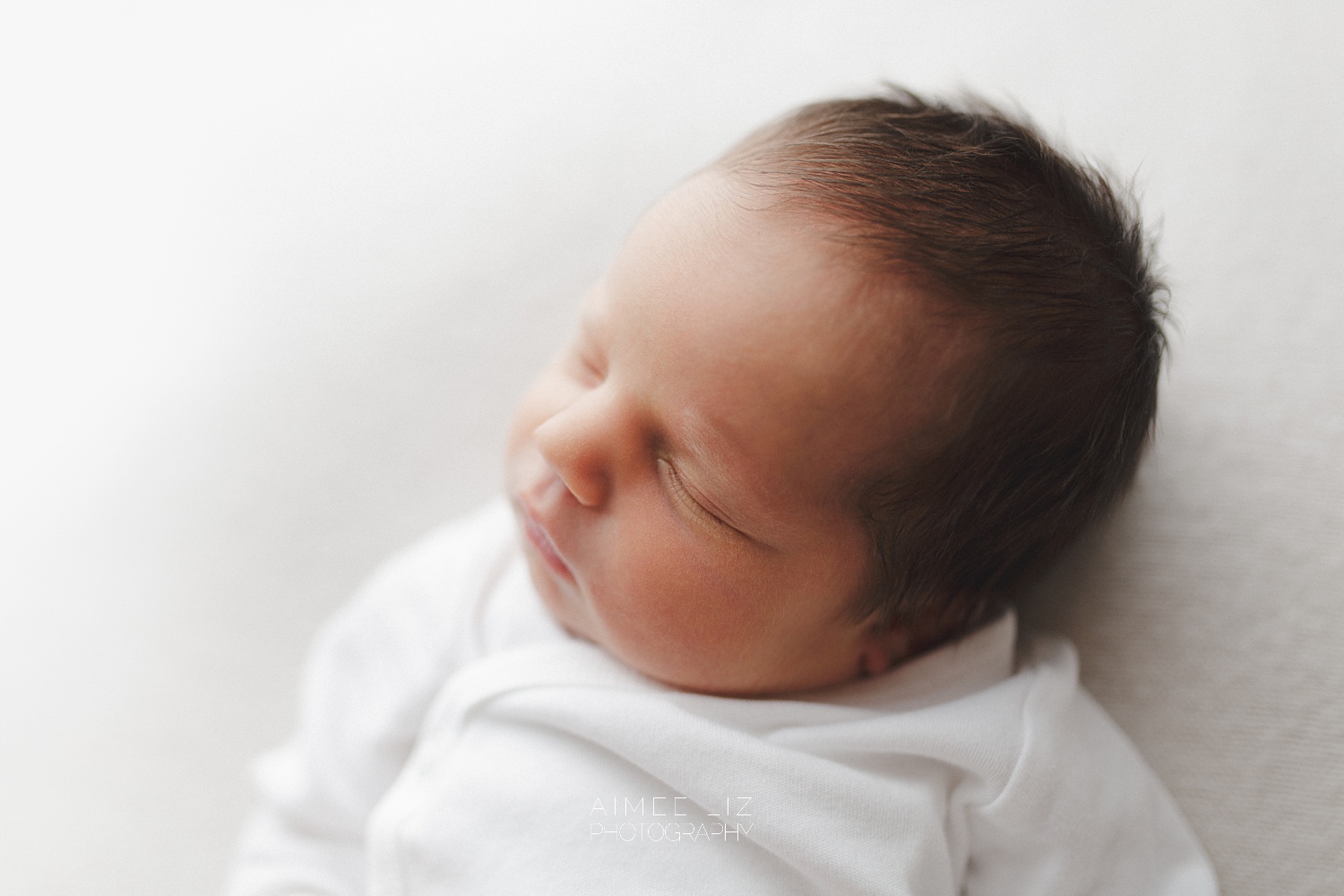 white onesie newborn photographer