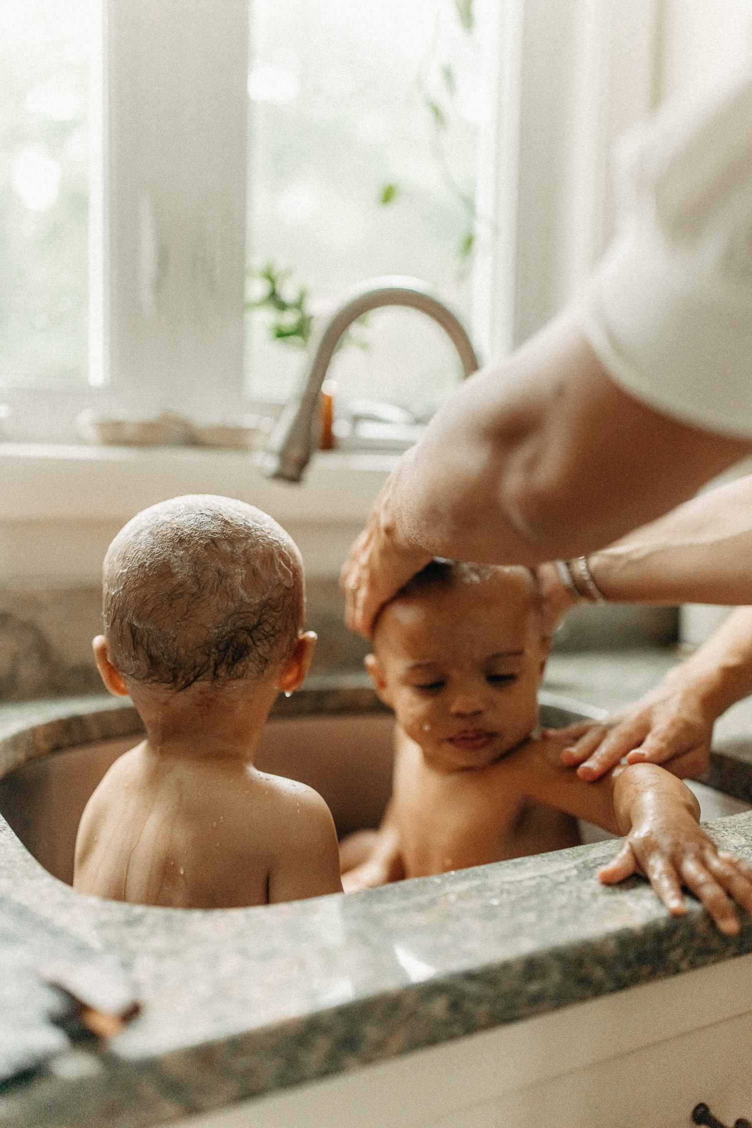 twin bath time during candid family photo session in massachusetts