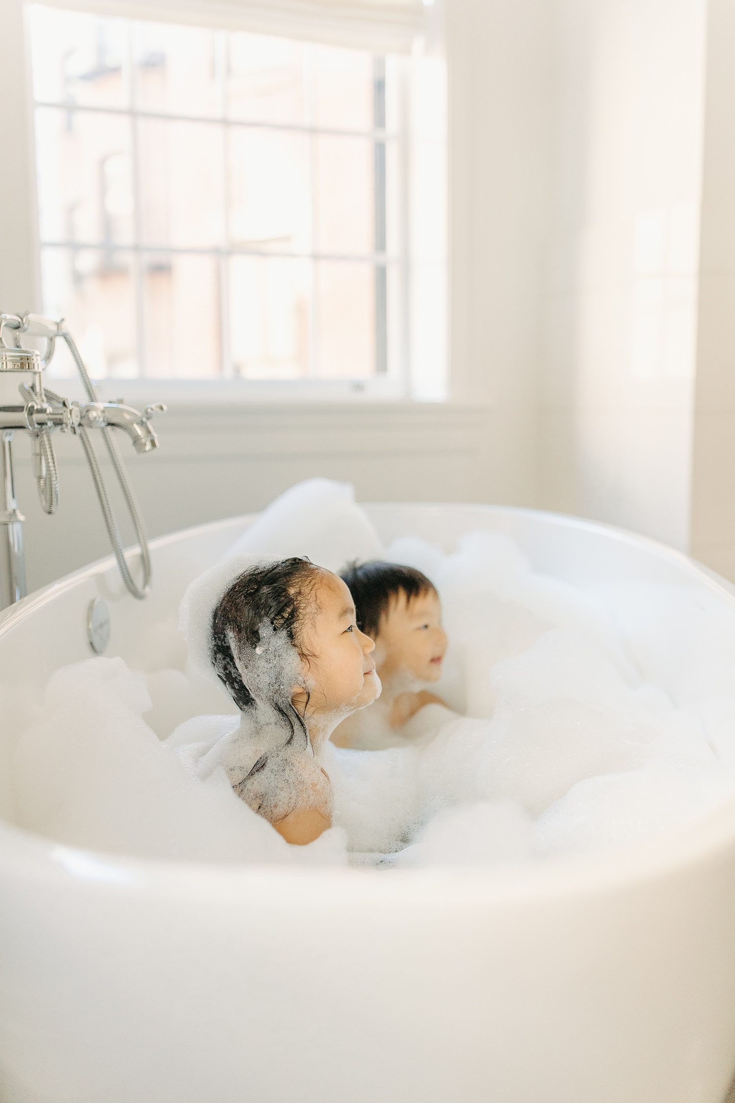 fun bubble bath photos during family photography session in boston