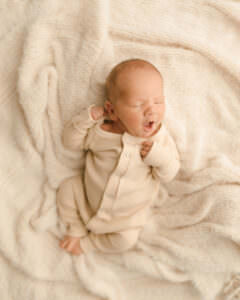 newborn photo session where baby has clothes on
